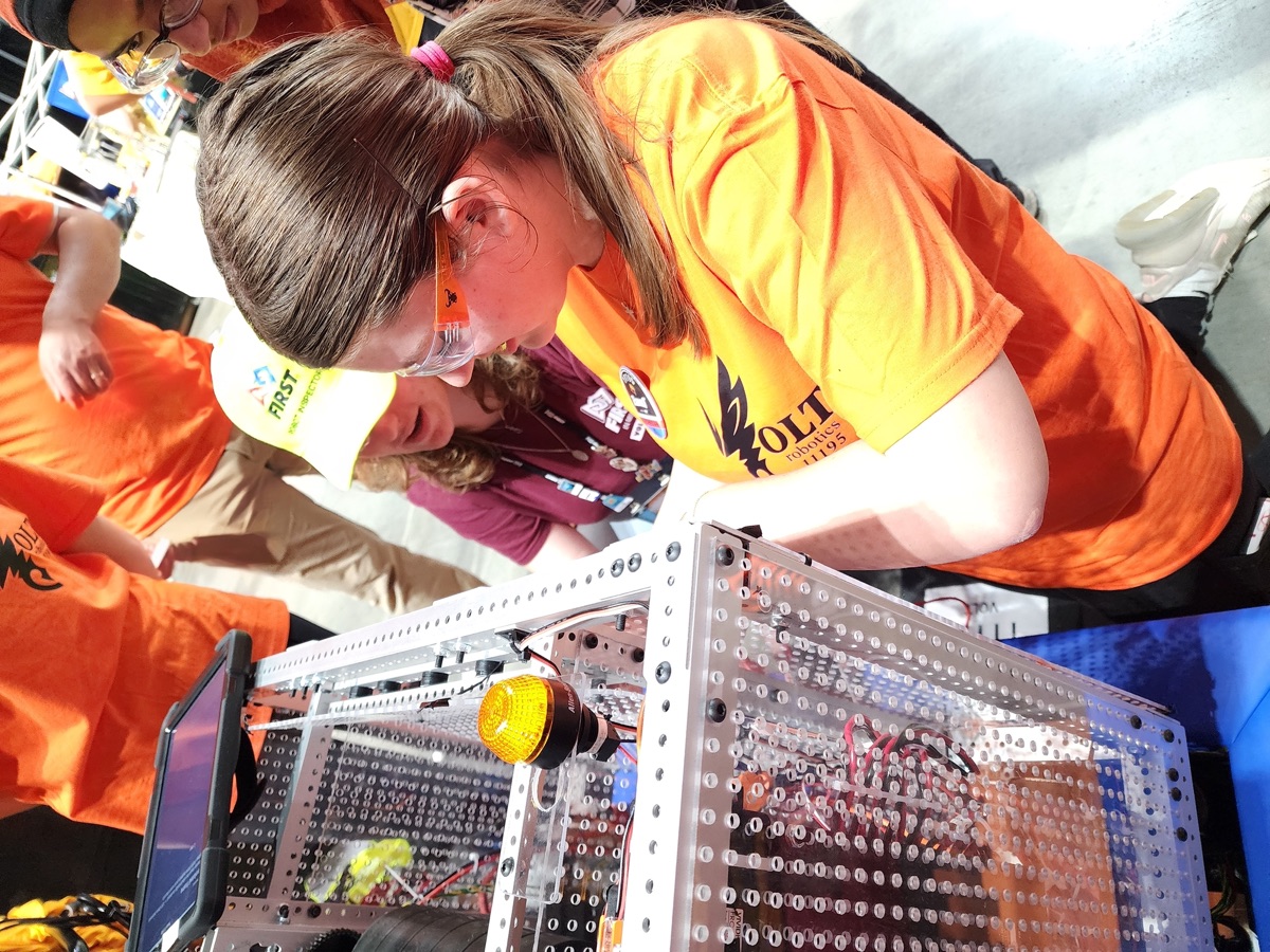 A VOLT student working on the robot